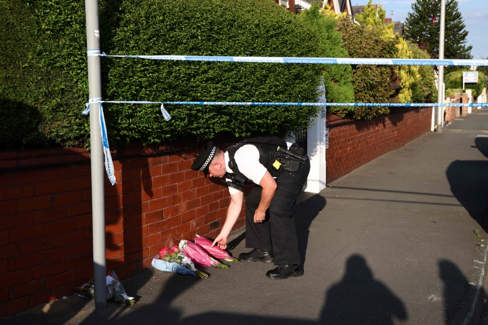 Flowers, teddy bears and tributes were left near the scene of yesterday’s stabbing spree at a Taylor Swift-themed dance class in Southport, near Liverpool, that also saw two adults and six children critically injured and three more children hurt. — AFP pic