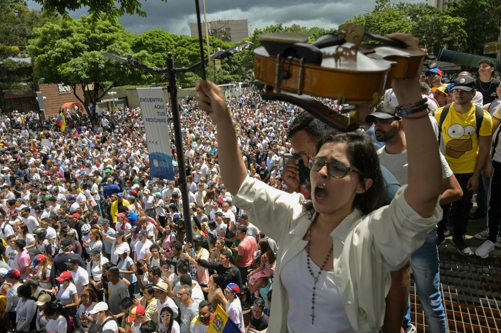 A musician opposing Venezuelan President Nicolas Maduro takes part in a rally called by presidential candidate Edmundo Gonzalez Urrutia and opposition leader Maria Corina Machado, in front of the United Nations headquarters in Caracas on July 30, 2024. — AFP pic
