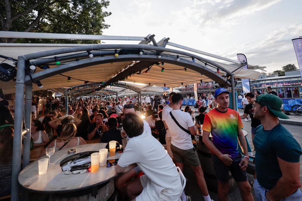 Participants enjoy during the opening ceremony of the Pride House - Paris 2024. — AFP