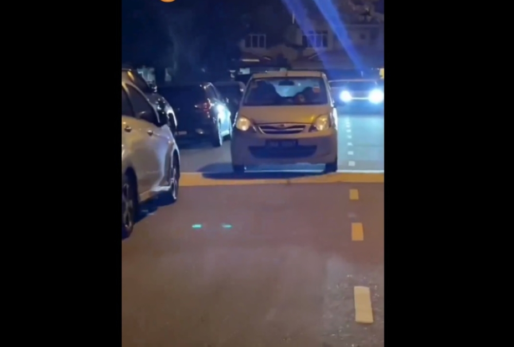 In the video, the car is seen speeding over a bump in front of a house before the woman intervened and ordered the vehicle to stop. — Screengrab from social media 