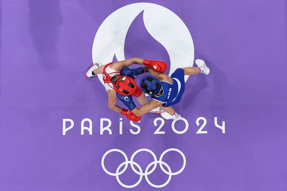 Algeria's Dounia Khelif (in red) fighting against Serbia's Natalia Shadrina in the women's 60kg preliminaries round of 16 boxing match during the Paris 2024 Olympic Games on July 29, 2024. — AFP pic