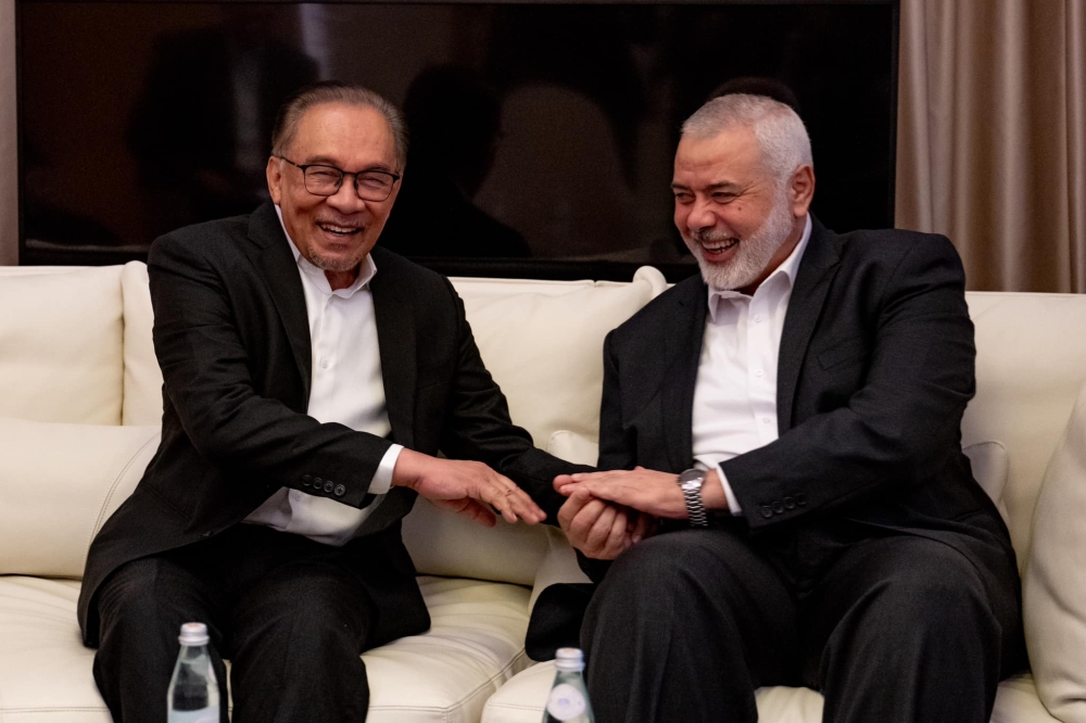 Prime Minister Datuk Seri Anwar Ibrahim meets with Hamas’ top political leader, Ismail Haniyeh (right), at a hotel in Doha, May 14, 2024. — Bernama pic