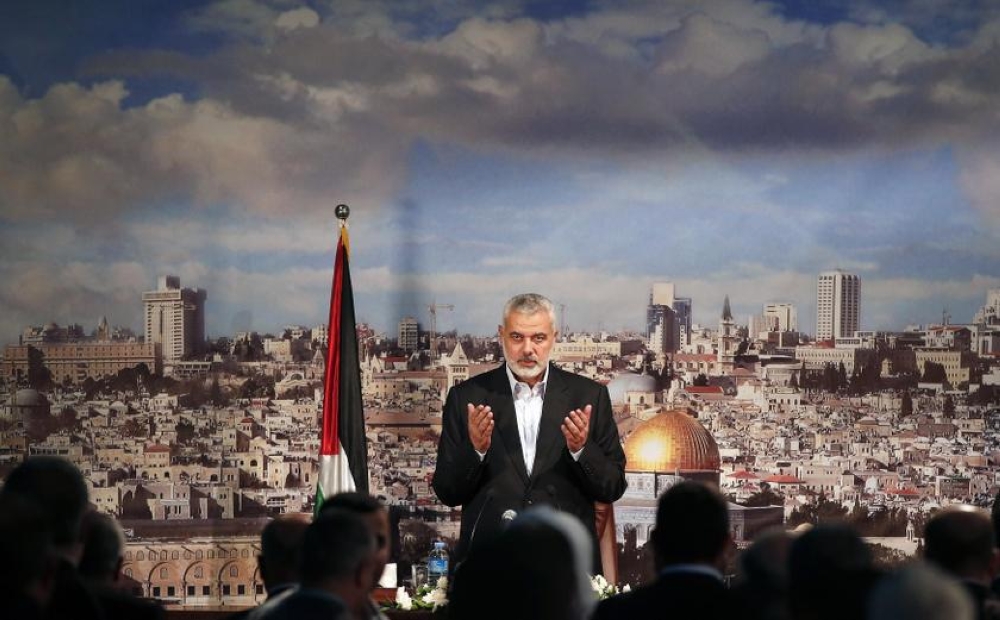 File photo of Hamas leader Ismail Haniyeh praying before delivering a speech in Gaza City October 19, 2013. — Reuters pic