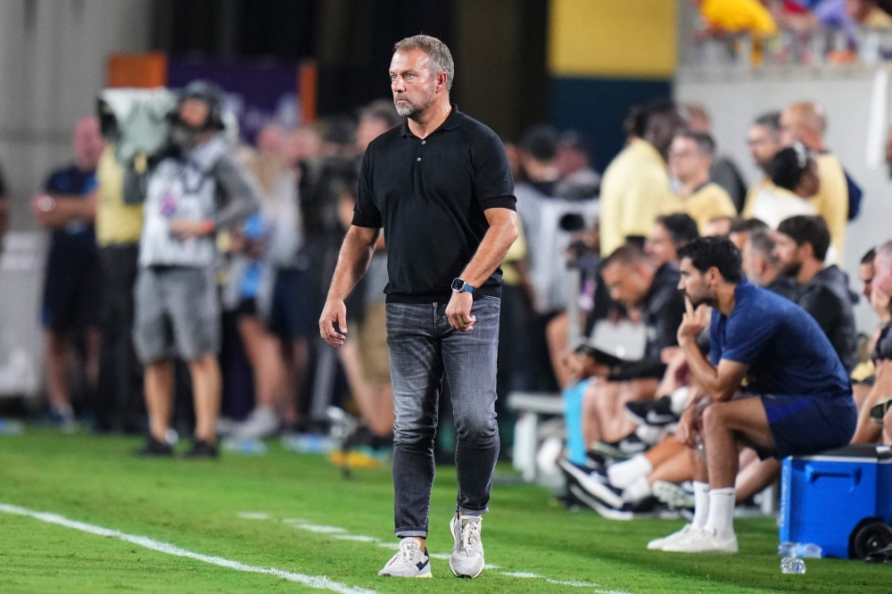 Barcelona manager Hansi Flick looks on from the sideline against the Manchester City during aa pre-season match yesterday. — AFP