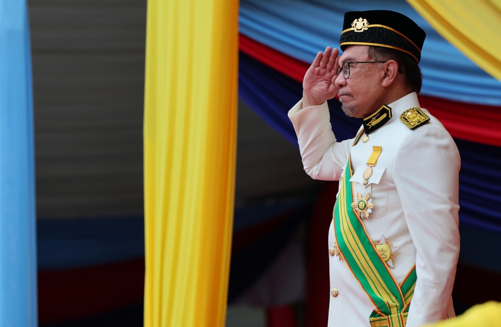 Prime Minister Datuk Seri Anwar Ibrahim salutes the security forces during a parade in conjunction with the 2024 Warriors’ Day celebration at Dataran Pahlawan Negara in Putrajaya, July 31, 2024. — Bernama pic