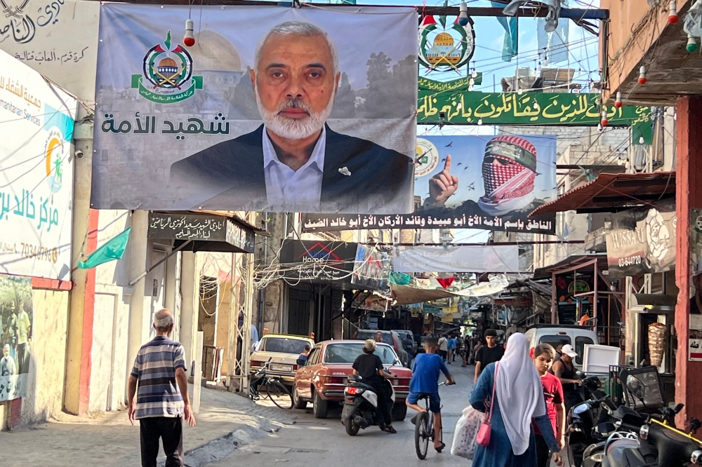 A large banner bearing a picture of slain Hamas political leader Ismail Haniyeh hangs in a street in the Palestinian refugee camp of Ain al-Hilweh, near the southern Lebanese city of Sidon on July 31, 2024. — AFP pic 