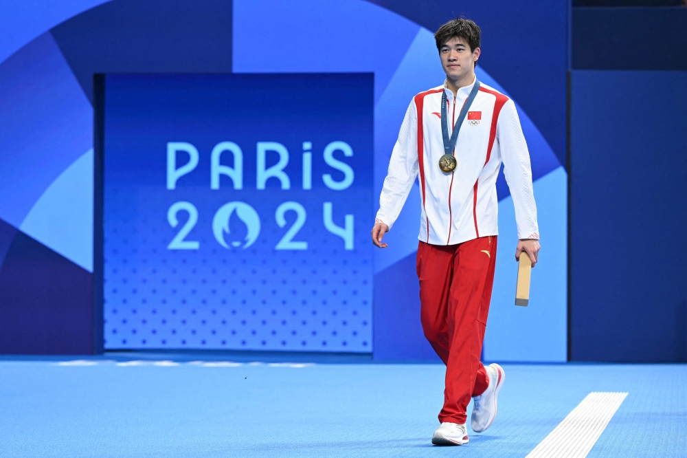 Gold medallist and world record holder China's Pan Zhanle walks next to the pool following the men's 100m freestyle swimming event during the Paris 2024 Olympic Games at the Paris La Defense Arena in Nanterre. — AFP pic