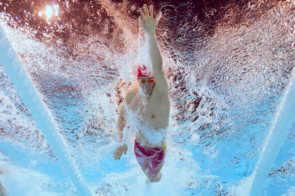 An underwater view shows China's Pan Zhanle competing in a heat of the men's 100m freestyle swimming event during the Paris 2024 Olympic Games at the Paris La Defense Arena in Nanterre, west of Paris, on July 30, 2024. — AFP pic
