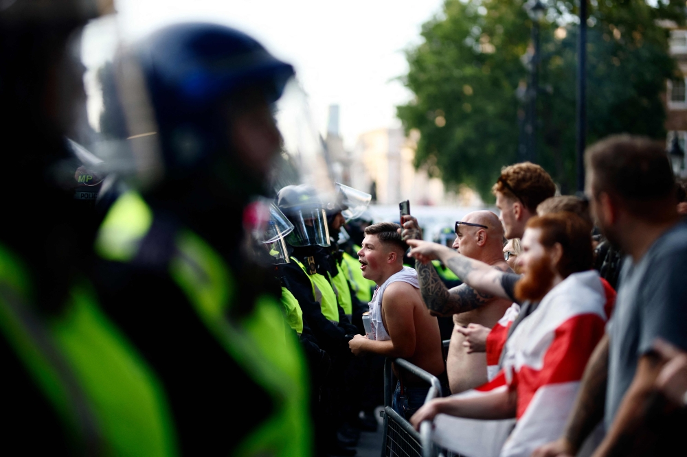 Protestors remonstrate with police officers during the ‘Enough is Enough’ demonstration on Whitehall, outside the entrance to 10 Downing Street in central London on July 31, 2024. — AFP pic