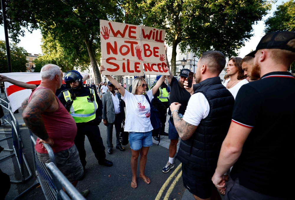 A protestor holds a banner reading ‘We Will Not Be Silenced’ during the ‘Enough is Enough’ demonstration on Whitehall, outside the entrance to 10 Downing Street in central London July 31, 2024. — AFP pic