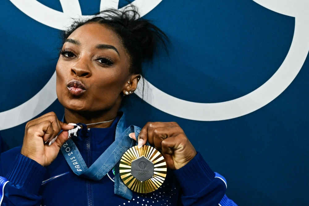Simone Biles’s sixth Olympic gold medal hung around her neck, and so did a twinkling little goat — just a reminder to the gymnast hailed as the greatest of all time that she does indeed belong in the pantheon of sports greats. — AFP pic
