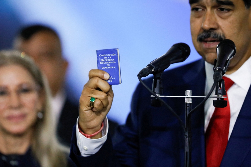 Venezuela's President Nicolas Maduro holds a constitution of Venezuela at the Supreme Court of Justice, in Caracas August 2, 2024. — Reuters pic  