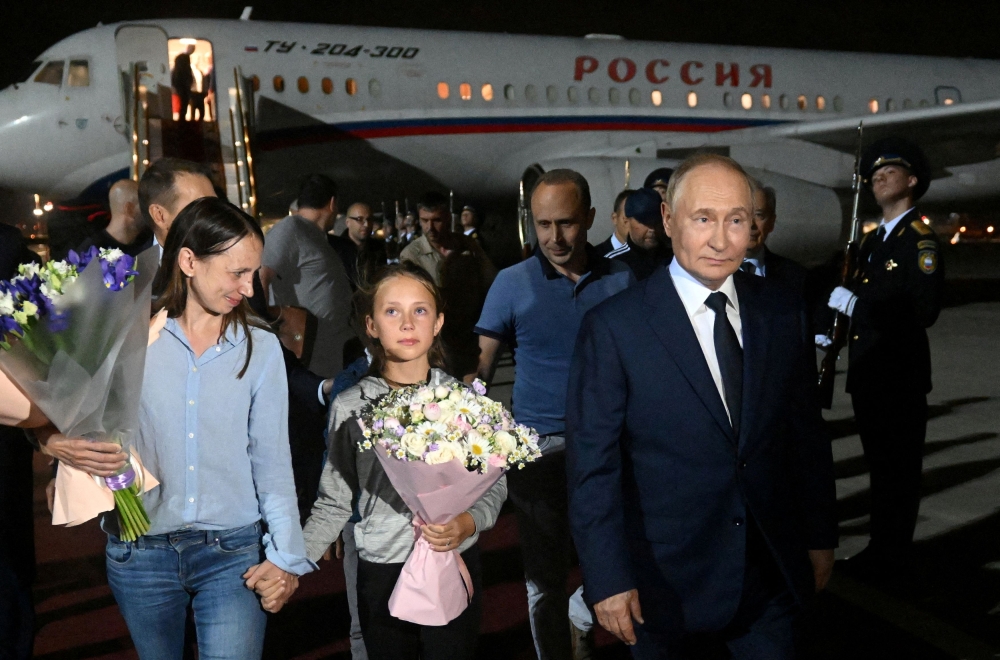 Russian President Vladimir Putin welcomes Russian nationals, including Artyom Dultsev, Anna Dultseva and their children, following a prisoner exchange between Russia with Western countries, during a ceremony at Vnukovo International Airport in Moscow August 1, 2024. — Sputnik/Mikhail Voskresensky/Pool pic via Reuters  