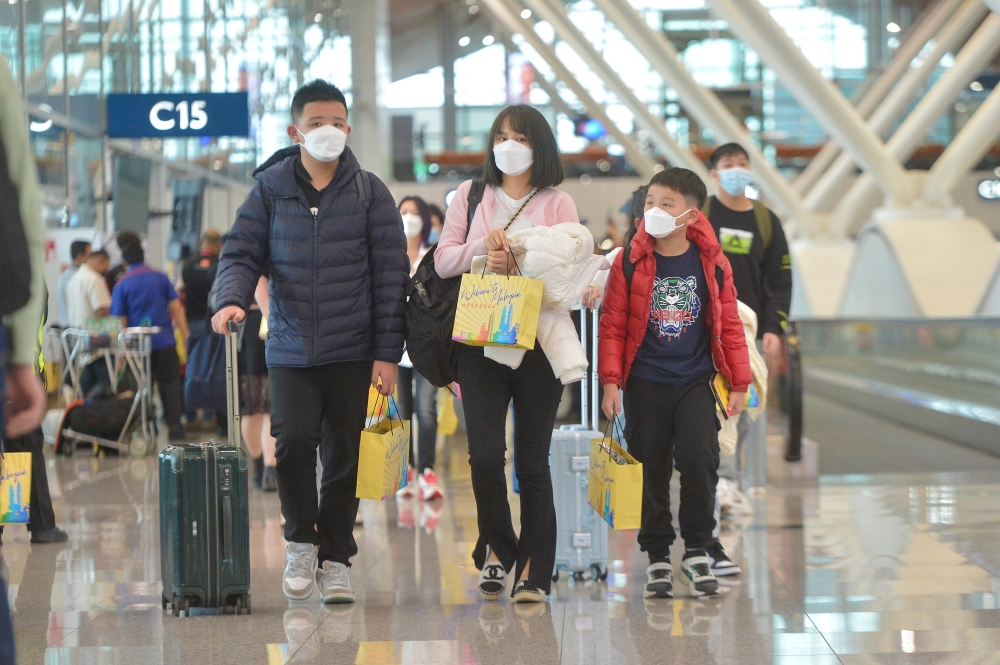 A file photograph shows travellers arriving the KLIA in Sepang in January 2023. — Picture by Shafwan Zaidon