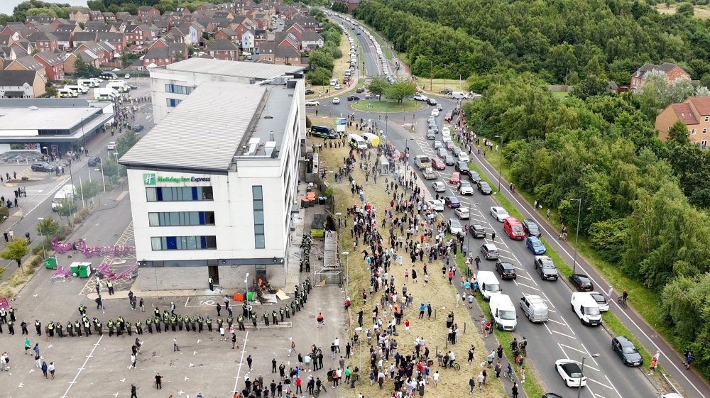 A drone view shows demonstrators protesting outside a hotel as police officers stand guard in Rotherham, Britain, August 4, 2024, in this screen grab obtained from a social media video. — Up North via Reuters