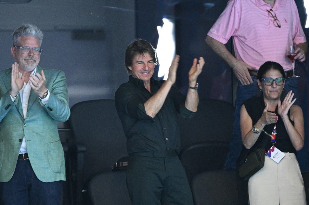Tom Cruise watches the victory ceremony of the women’s 4x100m freestyle relay swimming event at the Paris 2024 Olympic Games July 27, 2024. — AFP pic