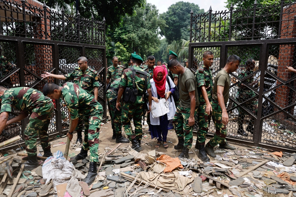Members of the army clear an entrance of the Ganabhaban, the Bangladeshi prime minister’s residence, a day after the resignation of Prime Minister Sheikh Hasina, in Dhaka August 6, 2024. — Reuters pic