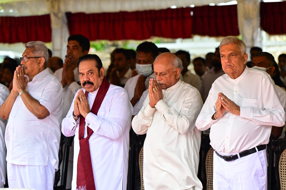 Sri Lanka’s president Ranil Wickremesinghe (right), former president Gotabaya Rajapaksa (left), former president Mahinda Rajapaksa (2nd left) and Prime Minister Dinesh Gunawardena (2nd right) attend the funeral of Buddhist monk, Galaboda Gnanaissara, in Colombo August 5, 2024. — AFP pic