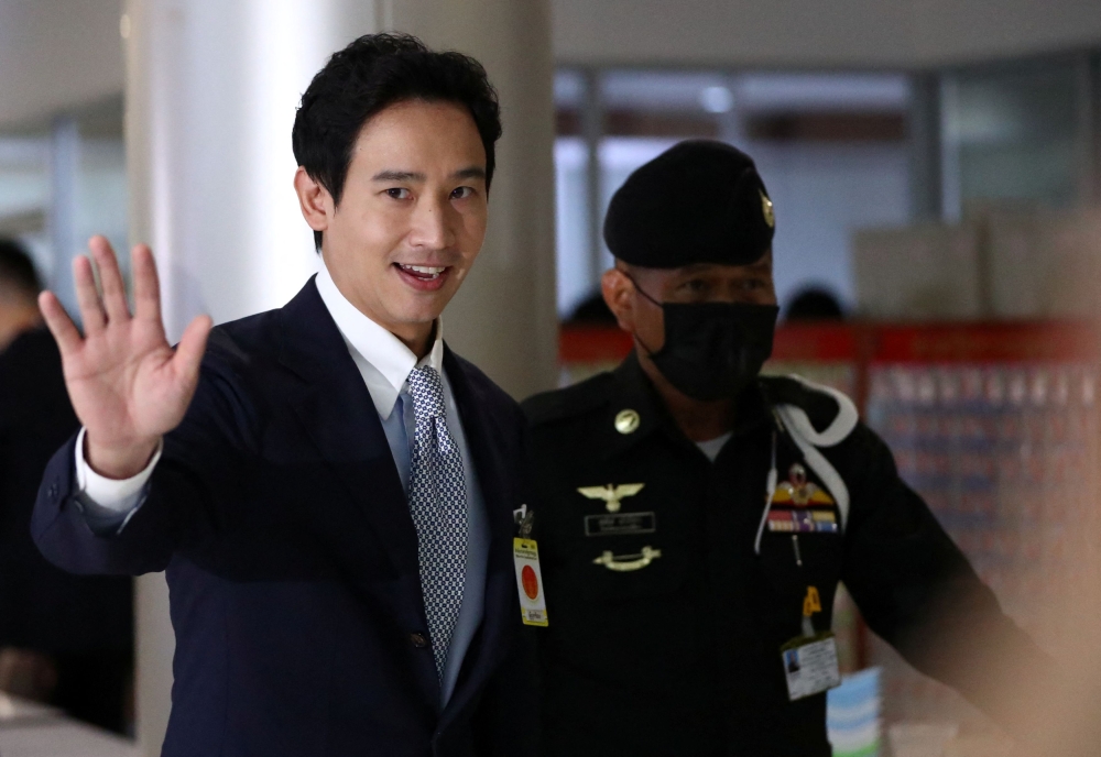 Former Move Forward Party leader Pita Limjaroenrat waves as he walks on the day Thailand’s Constitutional Court delivers its verdict on a case seeking the dissolution of the opposite group over its call for lese-majeste reform, in Bangkok August 7, 2024. — Reuters pic