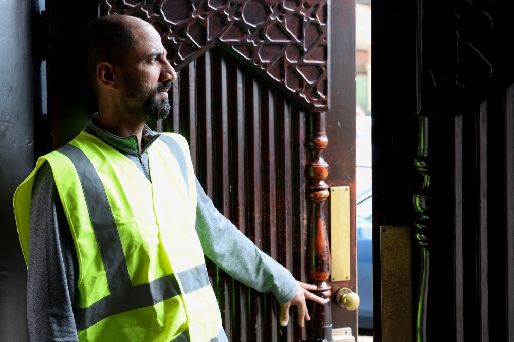 A volunteer monitors the surroundings of the Al Rahma Mosque, amid rioting across the country in which mosques and Muslims have been targets, in Liverpool August 6, 2024. — Reuters pic