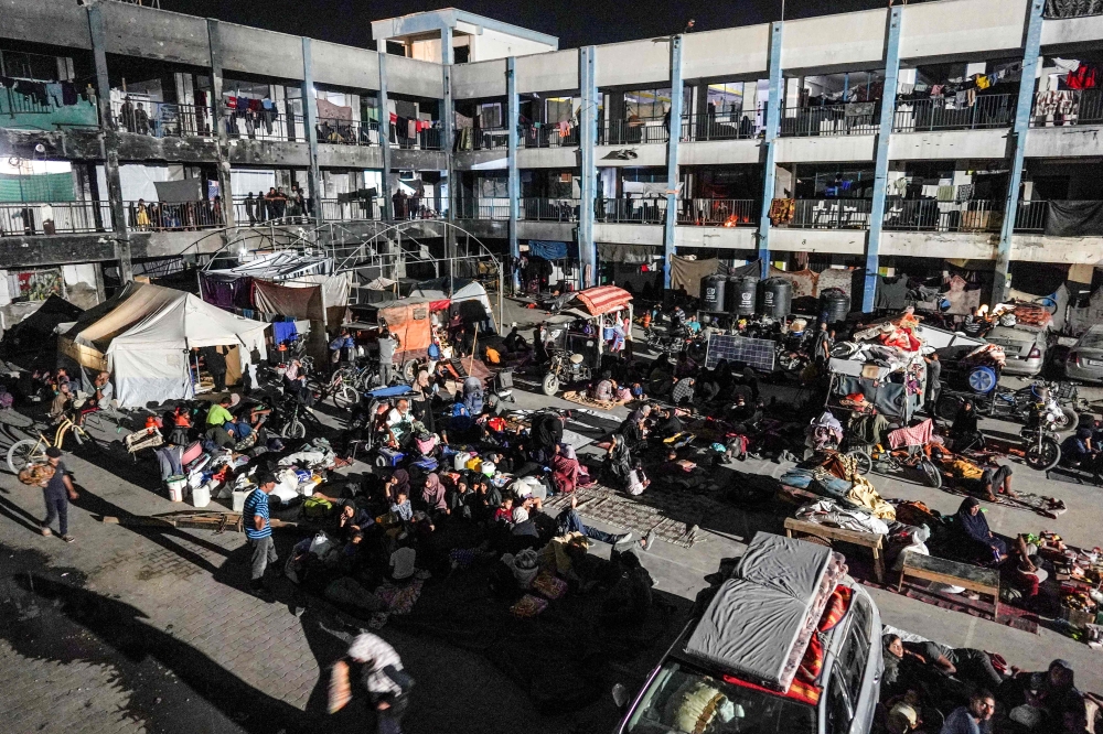 Displaced Palestinians spending the night in the courtyard of a UN school southern Gaza on August 8, 2024. — AFP pic