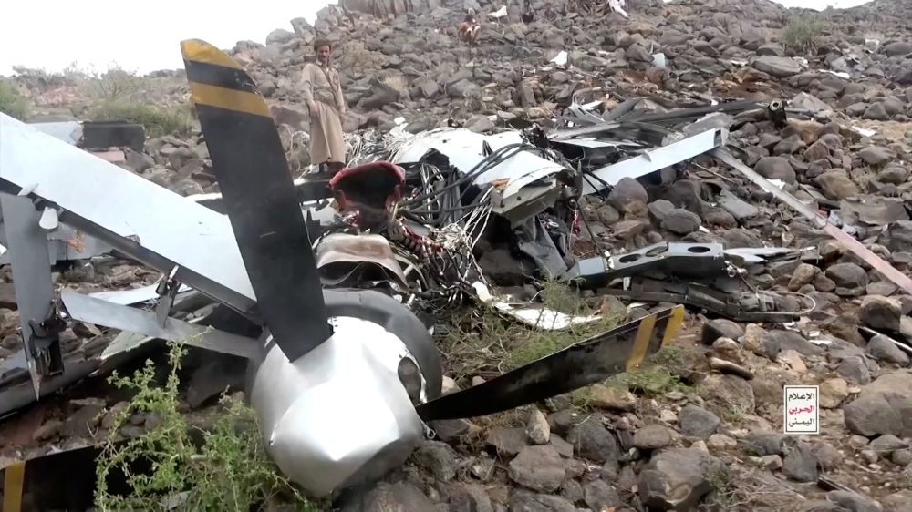 A man stands in the site of the wreckage of a US MQ-9 drone that Houthis claim they shot out of the sky, in a location given as Saada Governorate, Yemen in an undated screengrab obtained on August 4, 2024. — Reuters pic