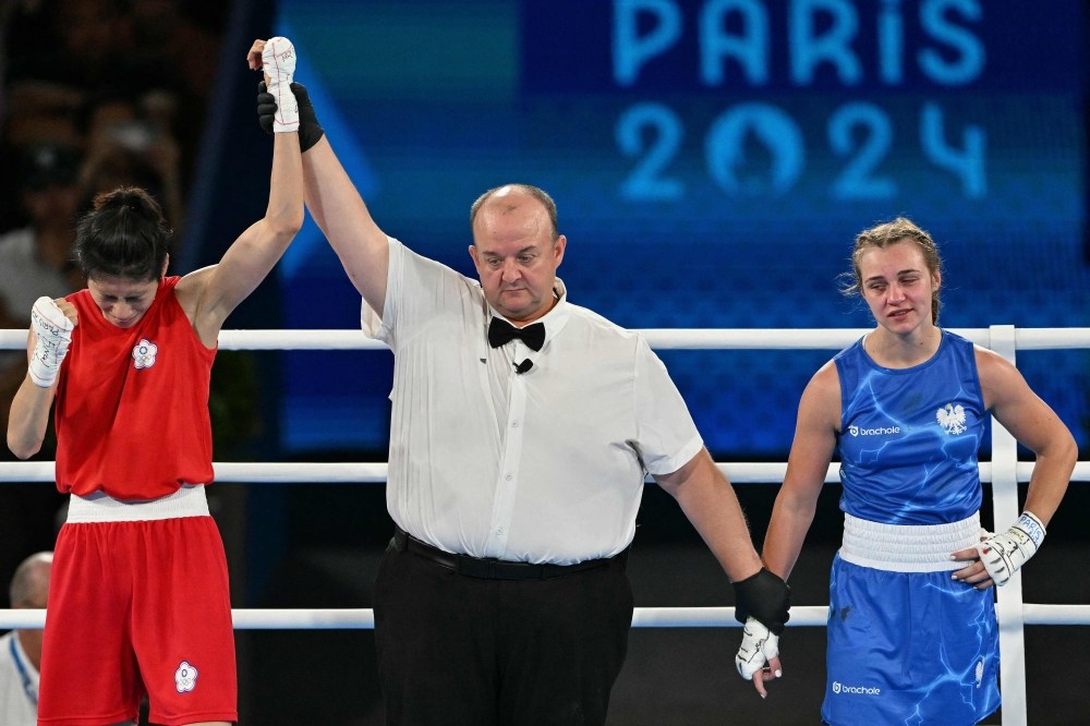 Taiwan's Lin Yu-ting reacts after beating Poland's Julia Szeremeta (Blue) in the women's 57kg final boxing match during the Paris 2024 Olympic Games at the Roland-Garros Stadium, in Paris on August 10, 2024. — AFP pic