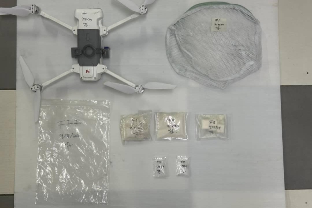 A Tapah Prison sergeant found a dhobi bag containing drugs attached to the drone. — Picture courtesy of PDRM