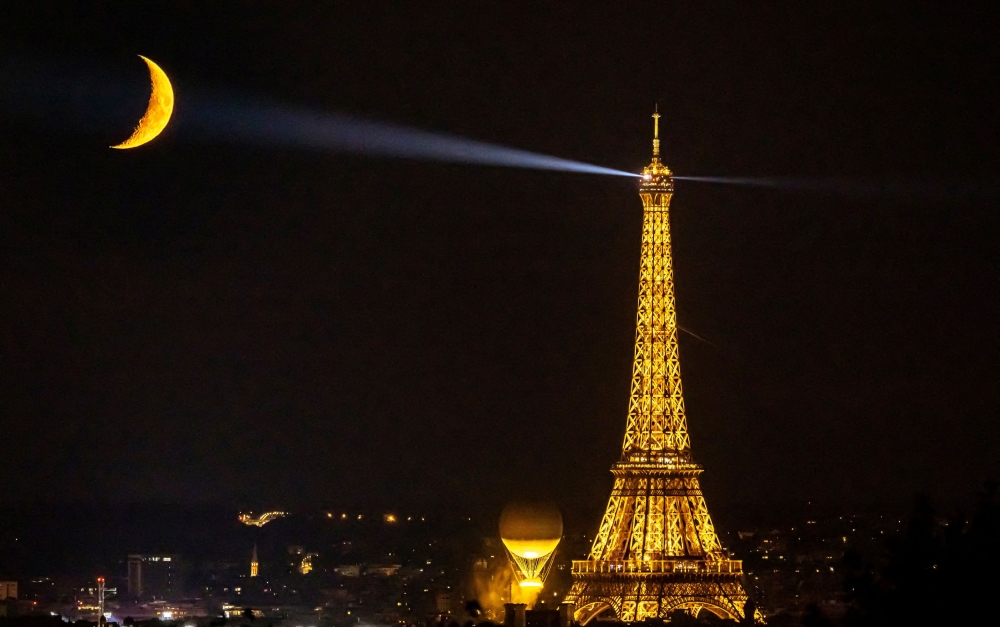 The moon is pictured with the Olympic cauldron and the Eiffel Tower. — Reuters pic