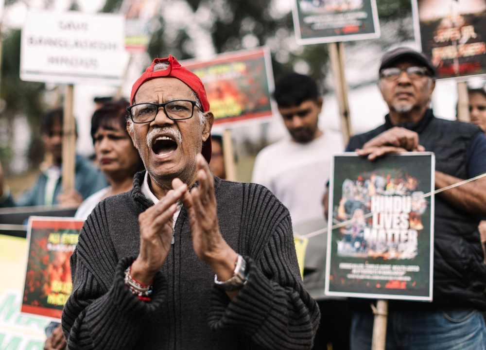 Members of the South African Hindu community hold posters as they chant slogans against violence targeting Bangladeshi Hindus and other minorities during a protest in Phoenix township, north of Durban  on August 11, 2024. — AFP pic