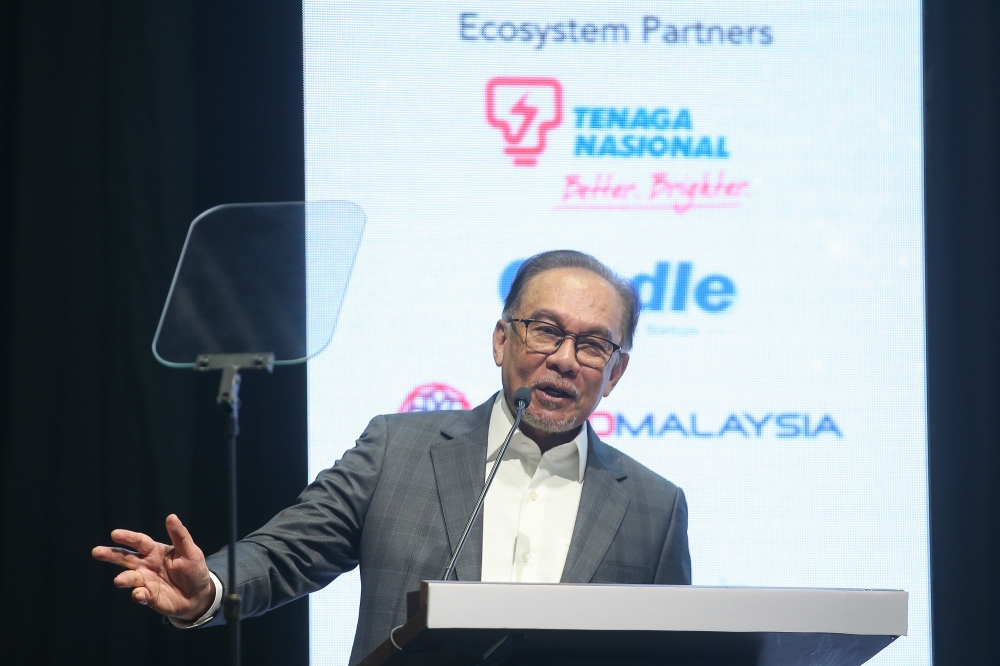 Prime Minister Datuk Seri Anwar Ibrahim speaks during the Malaysia Commercialisation Year Summit at the Kuala Lumpur Convention Centre on August 12, 2024. — Picture by Yusof Mat Isa