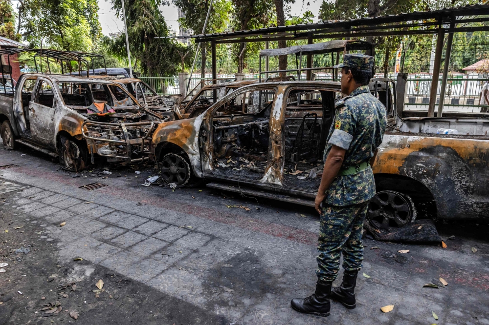 A member of the Bangladesh Army assesses the damages inside a Police station vandalised and burned by protesters during a student-led uprising that ended the 15-year rule of Sheikh Hasina in Dhaka on August 10, 2024. — AFP pic