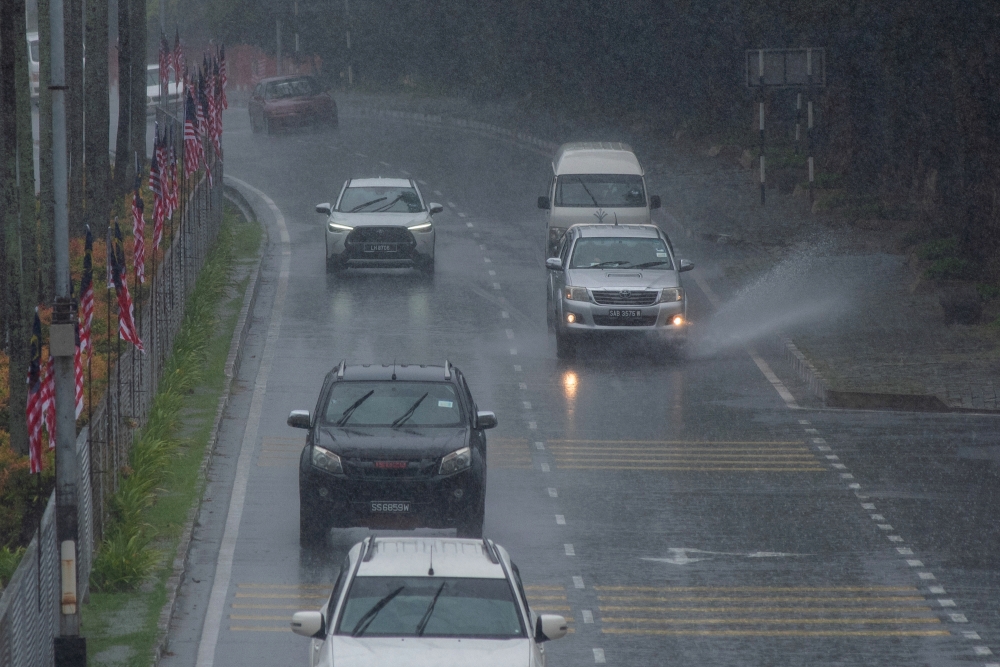 Motorists brave the rain that drenched the island since last night, as observed around Labuan town centre, August 12, 2024. — Bernama pic 