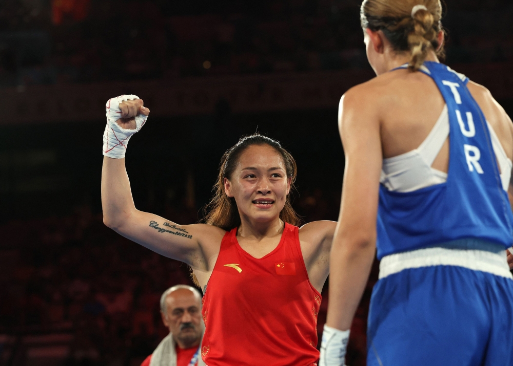 Chang Yuan of China celebrates winning against Hatice Akbas of Turkey. — Reuters pic