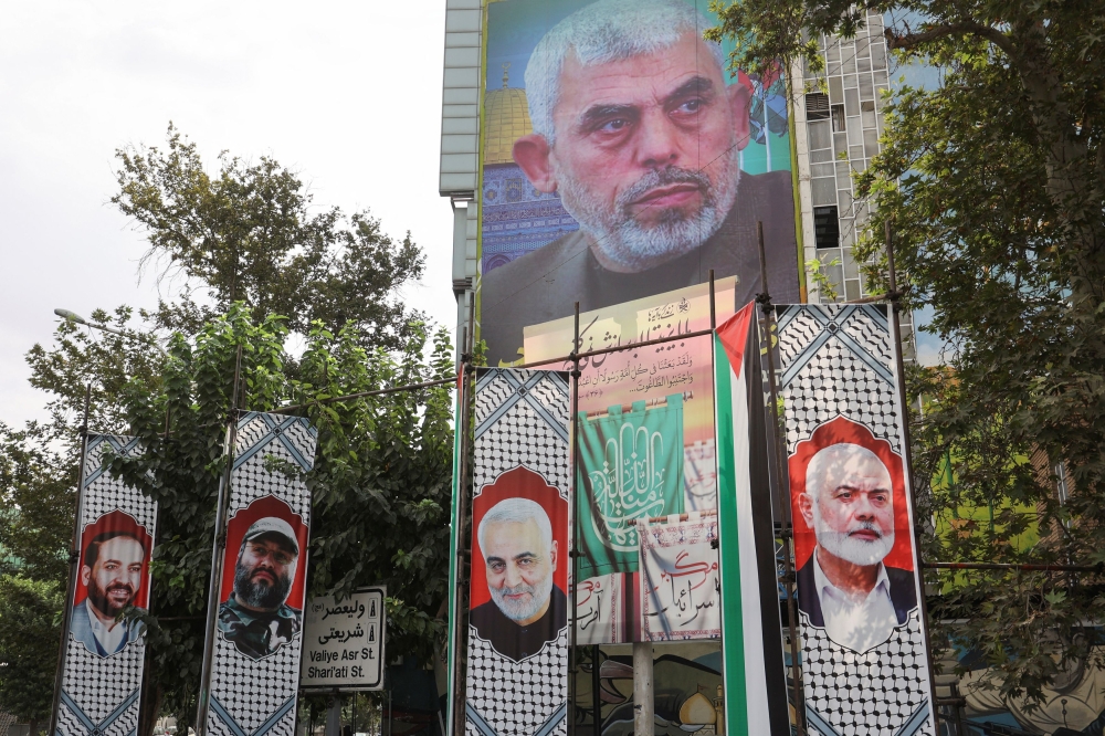 A billboard with a picture of newly appointed Hamas leader Yahya Sinwar is displayed on a building in a street in Tehran, Iran, August 12, 2024. — Wana via Reuters pic