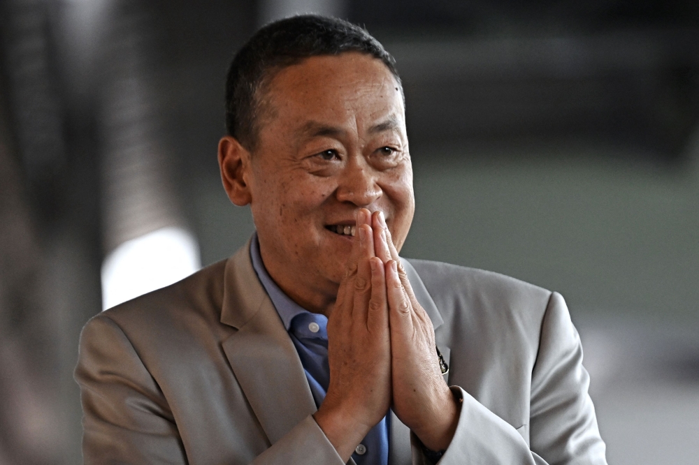 Thailand's Prime Minister Srettha Thavisin gestures as he arrives to visit a food market in Bangkok August 14, 2024. — AFP pic
