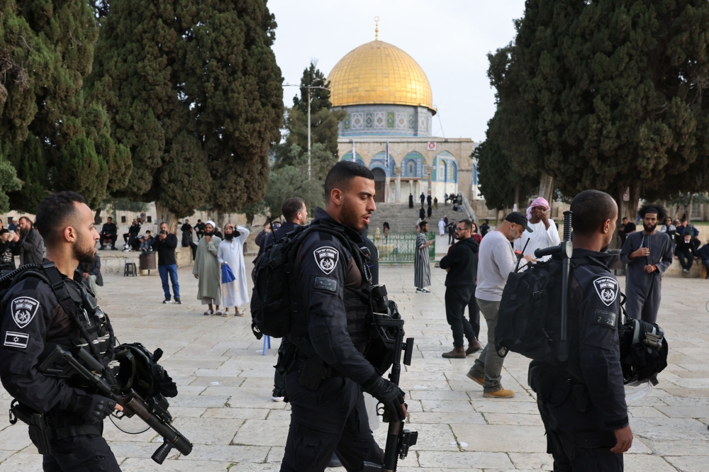 File picture of Jewish visitors walking protected by Israeli security forces at the Al-Aqsa mosque compound, also known as the Temple Mount complex to Jews, in Jerusalem on April 9, 2023, during the Muslim holy fasting month of Ramadan, also coinciding with the Jewish Passover holiday. The Malaysian government has strongly condemned the storming of the Al-Aqsa Mosque by Zionist Israeli extremists on August 13. — AFP pic 