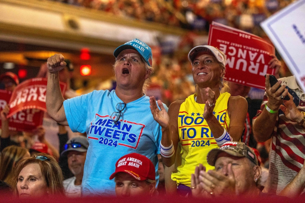 Attendees react prior to Republican presidential nominee former President Donald Trump speaking at a campaign event at Harrah's Cherokee Center on August 14, 2024. — AFP pic