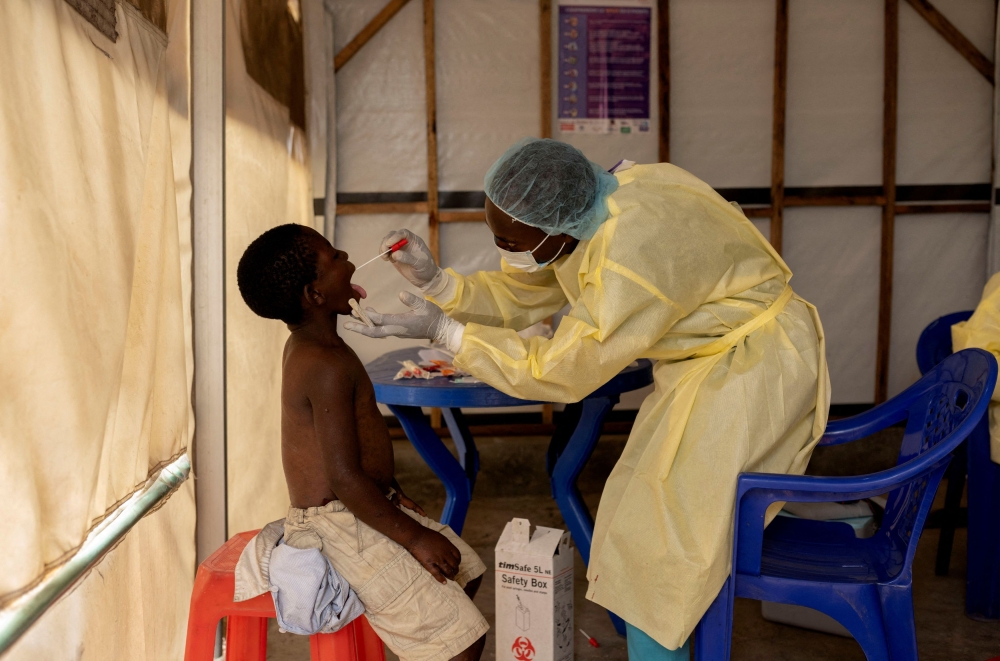 Christian Musema, a laboratory nurse, takes a sample from a child declared a suspected case Mpox — an infectious disease caused by the monkeypox virus that spark-off a painful rash, enlarged lymph nodes and fever; at the the treatment centre in Munigi, following Mpox cases in Nyiragongo territory near Goma, North Kivu province, Democratic Republic of the Congo July 19, 2024. — Reuters pic  