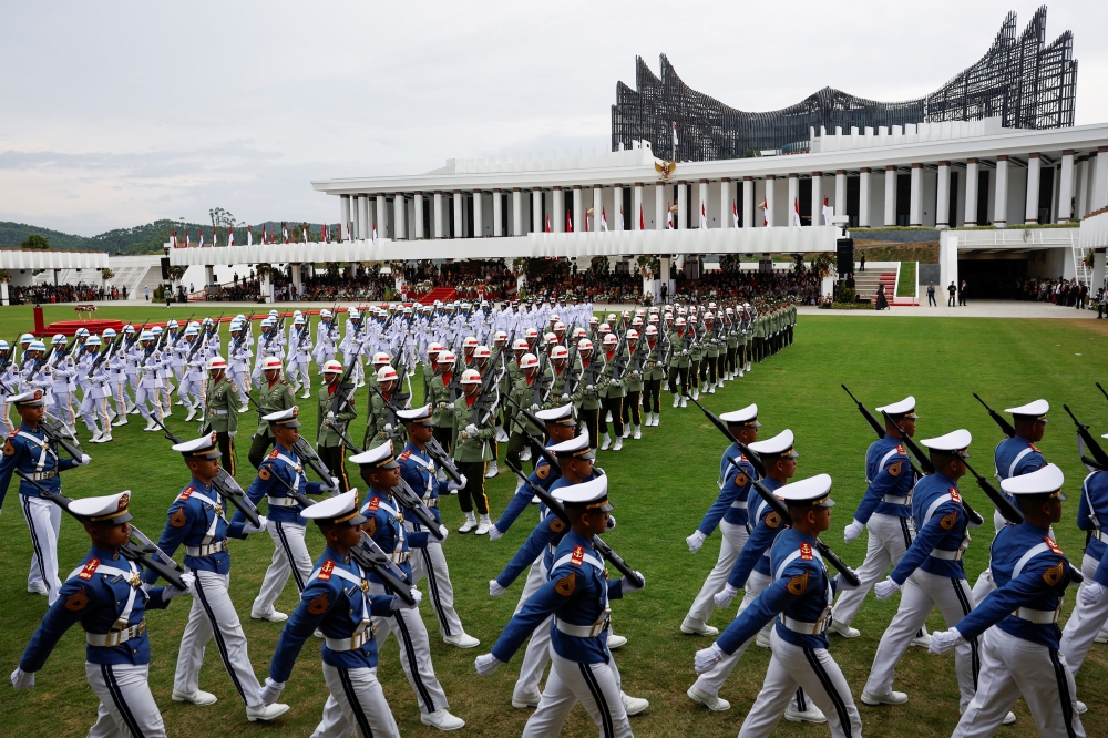 Indonesian military personnel march during a ceremony marking the country's 79th Independence Day at the Presidential Palace in the new capital city of Nusantara, East Kalimantan province August 17, 2024. — Reuters pic  