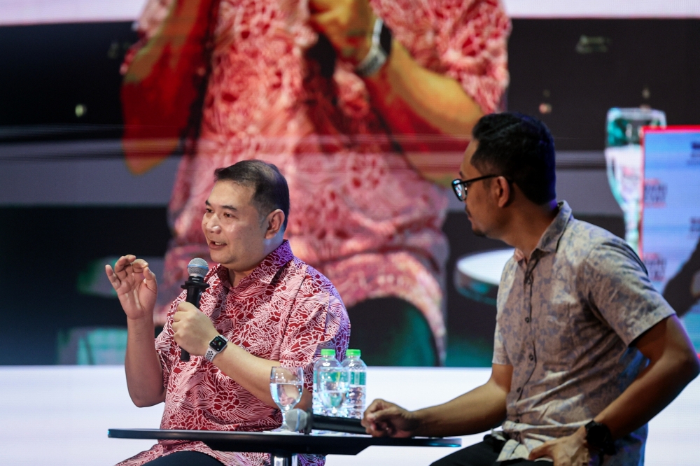 Economy Minister Rafizi Ramli (left) speaks in the ‘Ask Minister Anything’ forum during the Madani Rakyat Programme, Aug 17, 2024. — Bernama pic