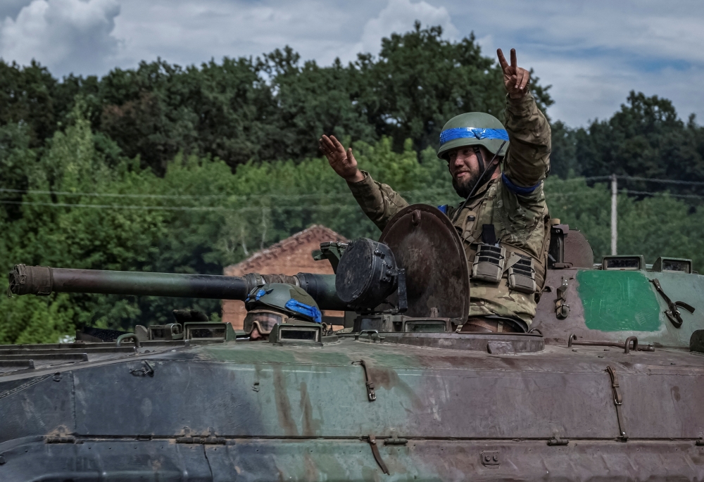 Ukrainian servicemen ride a BMP-1 infantry fighting vehicle, amid Russia's attack on Ukraine, near the Russian border in Sumy region, Ukraine August 10, 2024. — Reuters pic