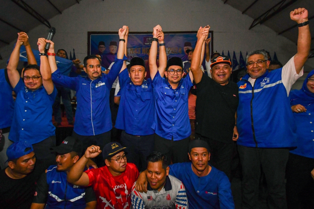 Barisan Nasional (BN) candidate Mohd Azmawi Fikri Abdul Ghani celebrates after being declared the winner of the Nenggiri State Legislative Assembly by-election at Dewan Perdana, Kompleks Perdana in Gua Musang August 17, 2024. — Bernama pic