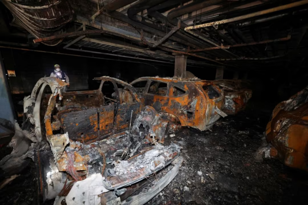 Burnt vehicles lying in the underground parking lot of an apartment complex in Incheon after a Mercedes EV caught fire. — Picture from Reuters