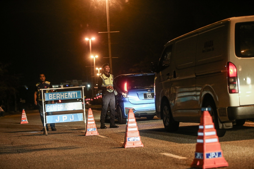 JPJ officers inspecting vehicles in Ipoh, Perak. —  Picture by Farhan Najib
