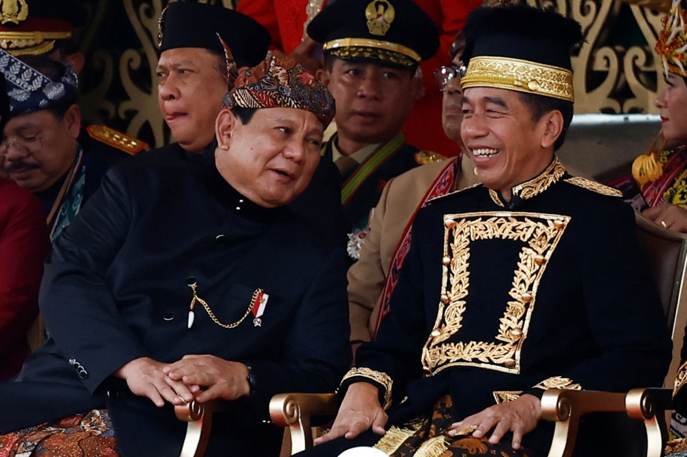 Indonesian President-elect and Defence Minister Prabowo Subianto talks with Indonesian President Joko Widodo during the country's 79th Independence Day celebration at the Presidential Palace in the new capital city of Nusantara, East Kalimantan province, Indonesia, August 17, 2024. — Reuters pic