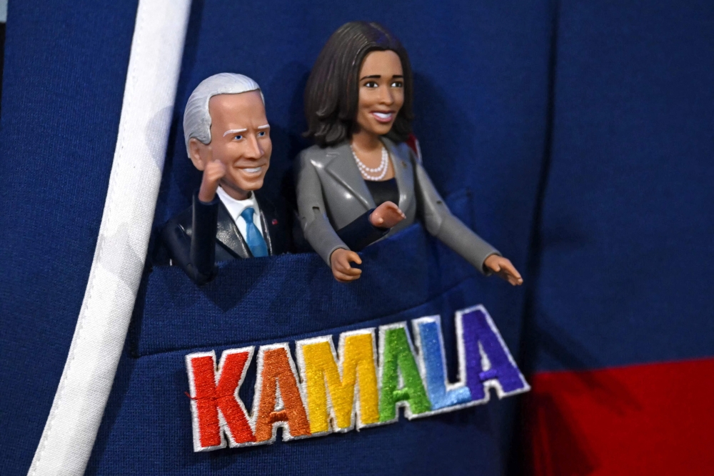 Figurines of US President Joe Biden (left) and US Vice President and 2024 Democratic presidential candidate Kamala Harris are pictured inside the pocket of the jacket of a California delegate on the first day of the Democratic National Convention (DNC) at the United Center in Chicago, Illinois, on August 19, 2024. — AFP pic