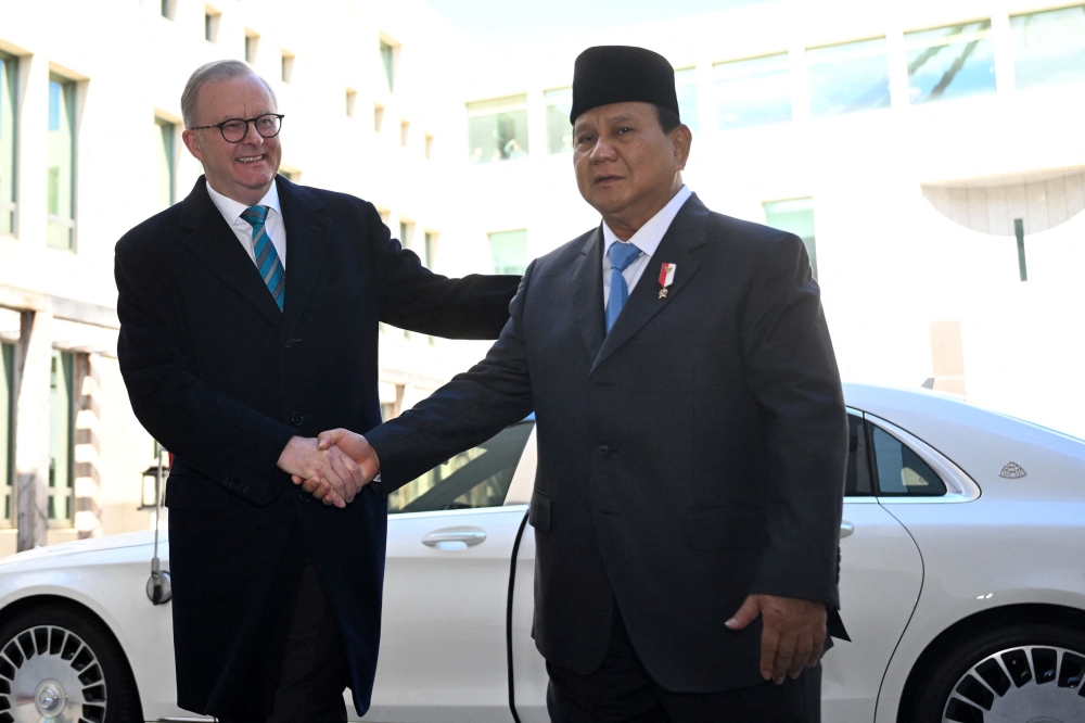 Indonesia's President-elect Prabowo Subianto shakes hands with Australia's Prime Minister Anthony Albanese ahead of a meeting at Parliament House in Canberra, Australia, August 20, 2024 — Reuters pic