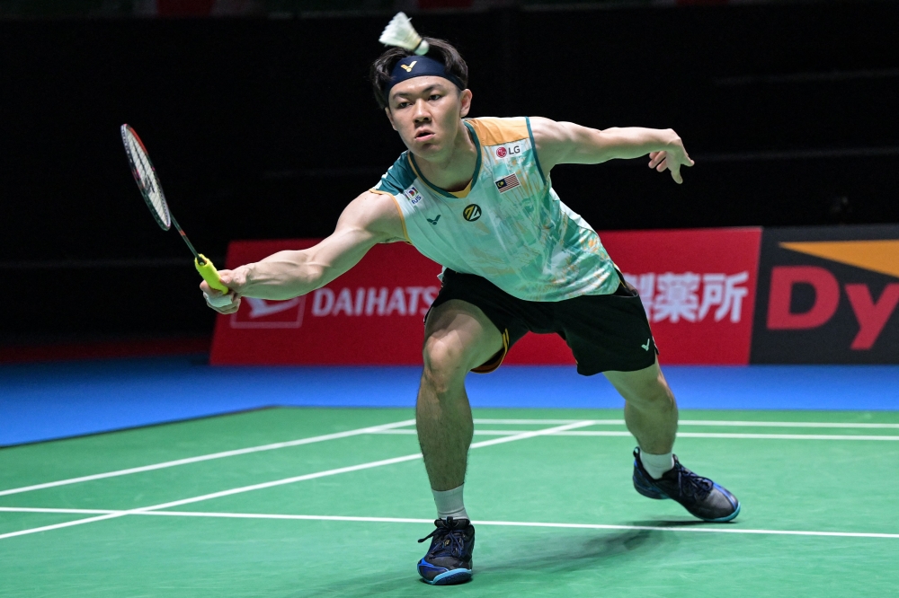 Malaysia's Lee Zii Jia hits a return against France's Alex Lanier during their men's singles match on the first day of the Japan Open, August 20, 2024. — AFP pic