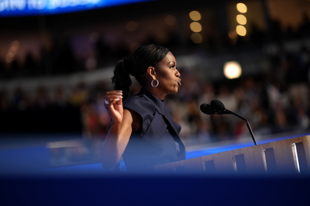 “Something magically wonderful is in the air... It’s the contagious power of hope,” she told adoring attendees ahead of former president Barack Obama’s address. — AFP pic